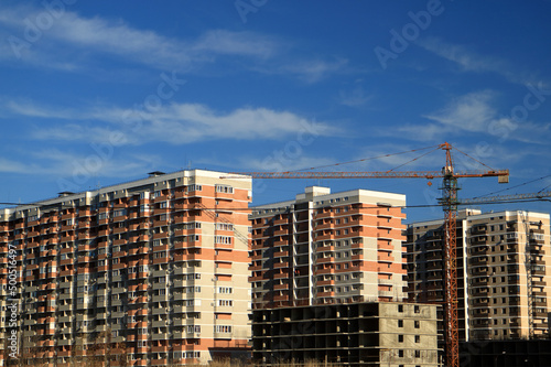 Tower cranes are working on the construction of a new house. Lifting crane.