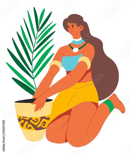 Woman planting exotic foliage florist composition