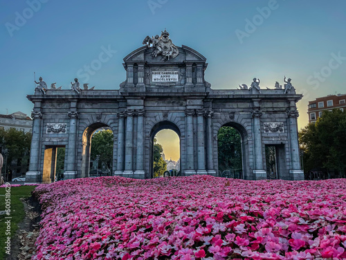 Beautiful view of the iconic (Puerta de alcala) alcala gate in spring, cover in flowers on a sunset 