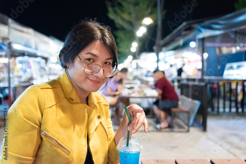 Woman (LGBTQ) posing with food at thai street food photo