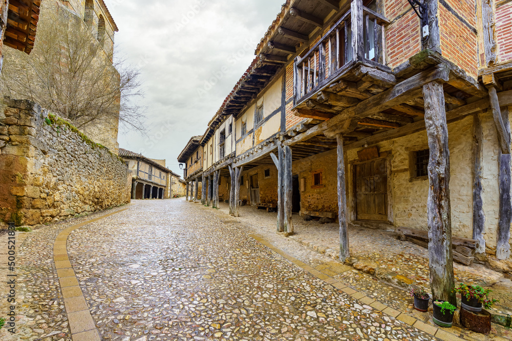 Medieval wooden arcades and balconies hanging in Calatanazor, Spain.
