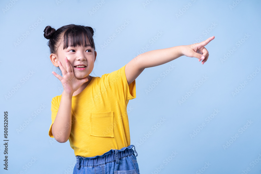 Image of Asian child posing on blue background Image of Asian child posing on blue background