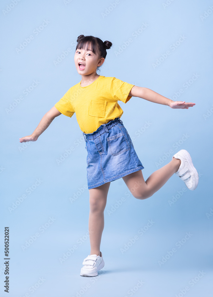 Image of Asian child posing on blue background Image of Asian child posing on blue background