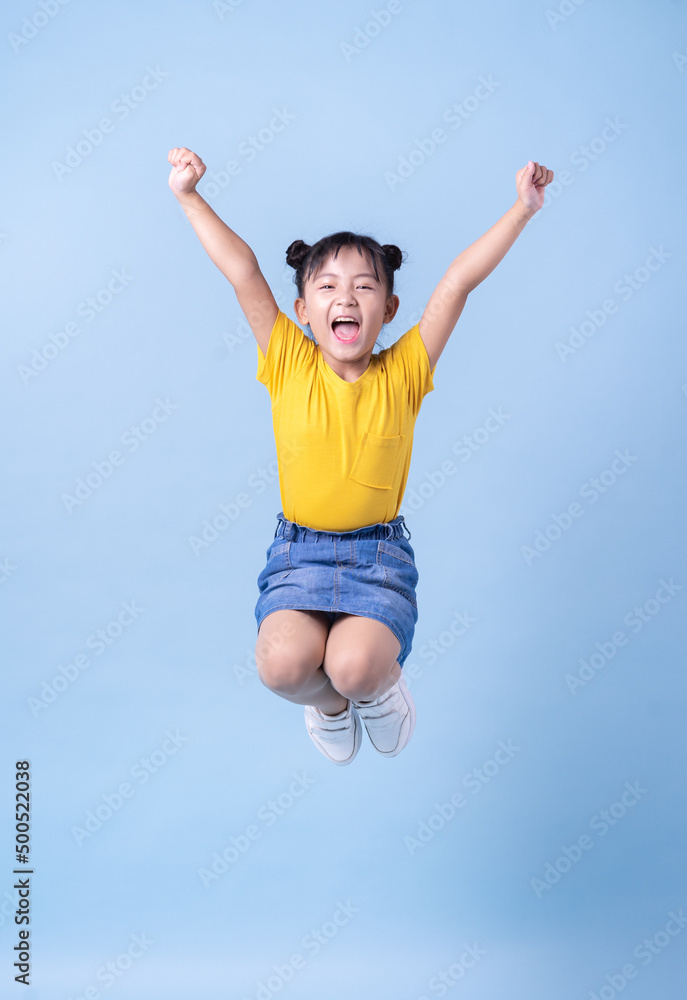 Image of Asian child posing on blue background