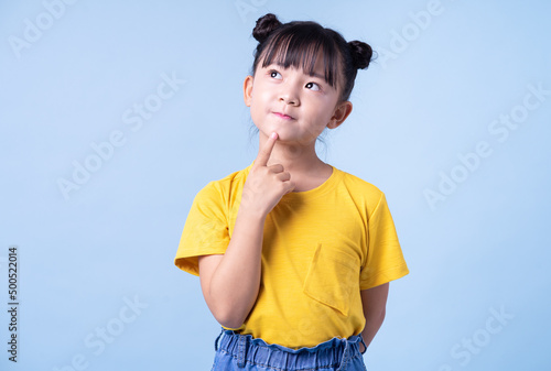 Image of Asian child posing on blue background