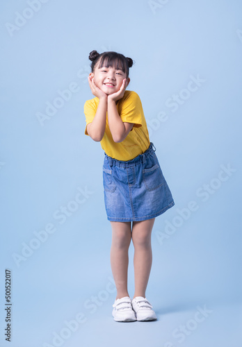 Image of Asian child posing on blue background © Timeimage