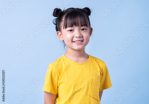 Image of Asian child posing on blue background