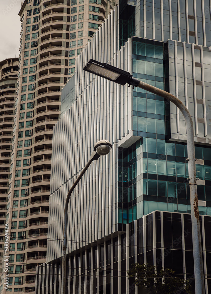 Street lamps against the background of Modern architecture by Afternoon sun. No focus, specifically.