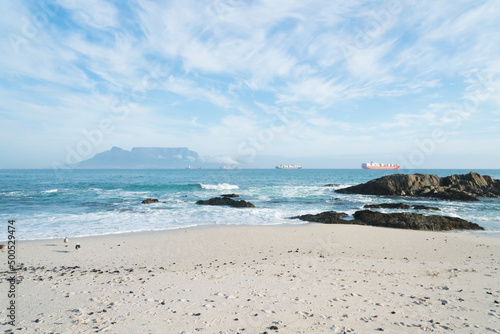 landscape view of Table Mountain and container ships anchored in Table bay from Bloubergstrand beach Cape Town