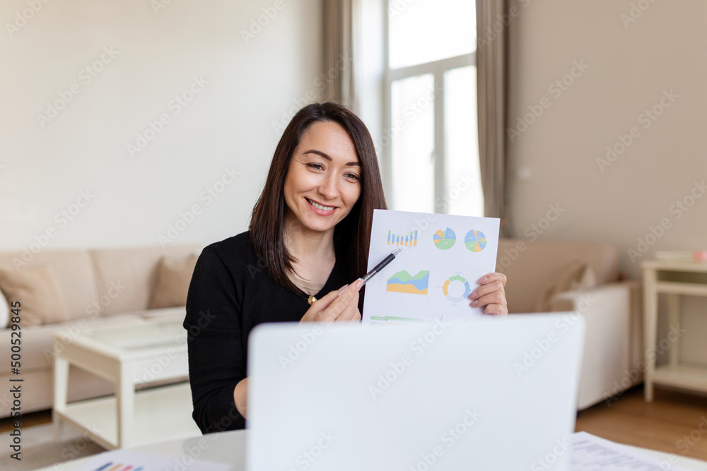 Businesswoman presenting charts and graphs on video call online. Middle-aged Business woman having conference call with client on laptop. Closeup business woman working laptop computer indoor. Businesswoman presenting charts and graphs on video call online. Middle-aged Business woman having conference call with client on laptop. Closeup business woman working laptop computer indoor.