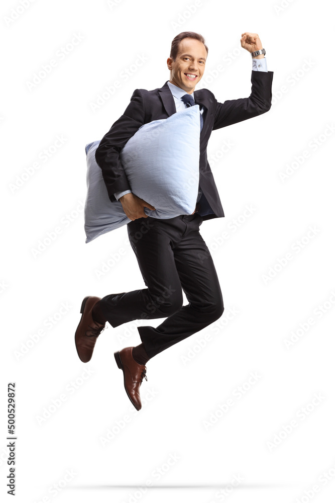 Full length shot of a happy businessman holding a pillow and jumping Full length shot of a happy businessman holding a pillow and jumping