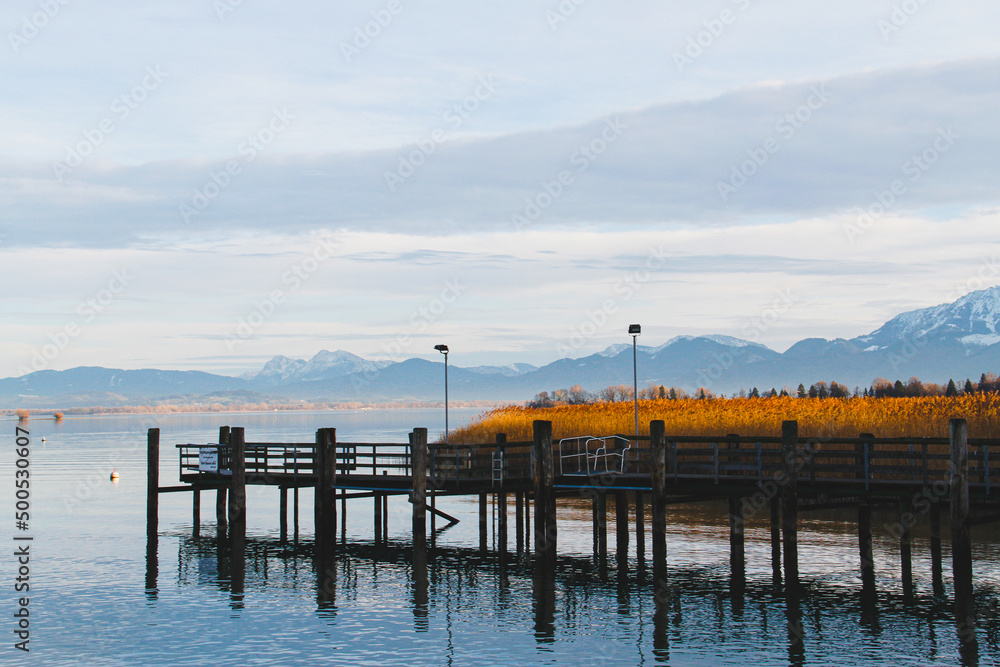 Pier on the Chiemsee, Bavaria Germany. Bavarian alps visible on the horizon