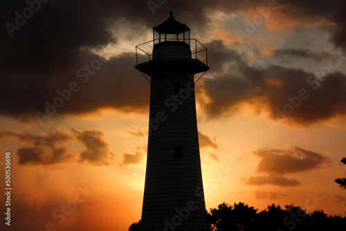 Silhouette of a lighthouse amidst a dramatic sunset background. Cleveland Point, Brisbane, Australia.