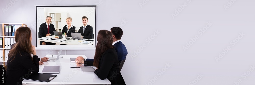 Group Of Businesspeople Looking At Projector Group Of Businesspeople Looking At Projector