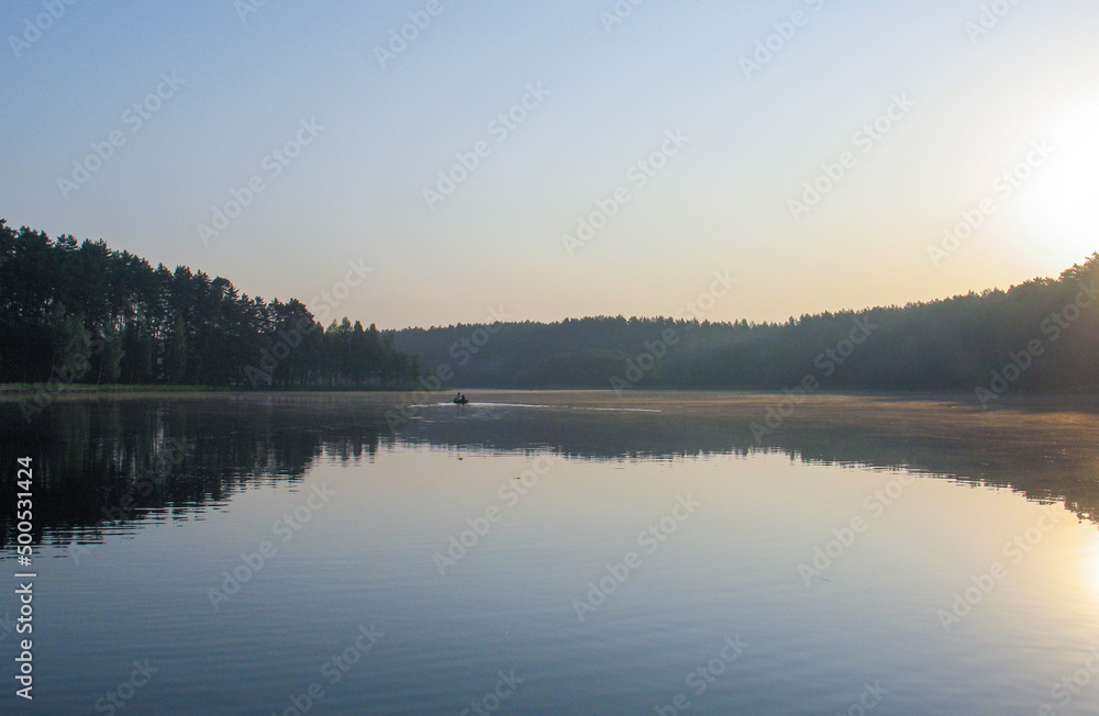 Fishing Lake. Early Morning Mist Over the Lake. Silent and still forest lake. Dawn fishing. Resting in nature. Two Men in a Boat