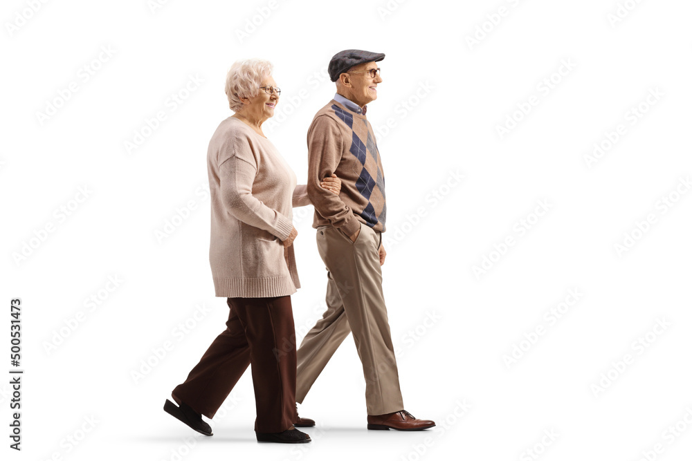 Full length profile shot of an elderly man and woman walking hand in hand Full length profile shot of an elderly man and woman walking hand in hand