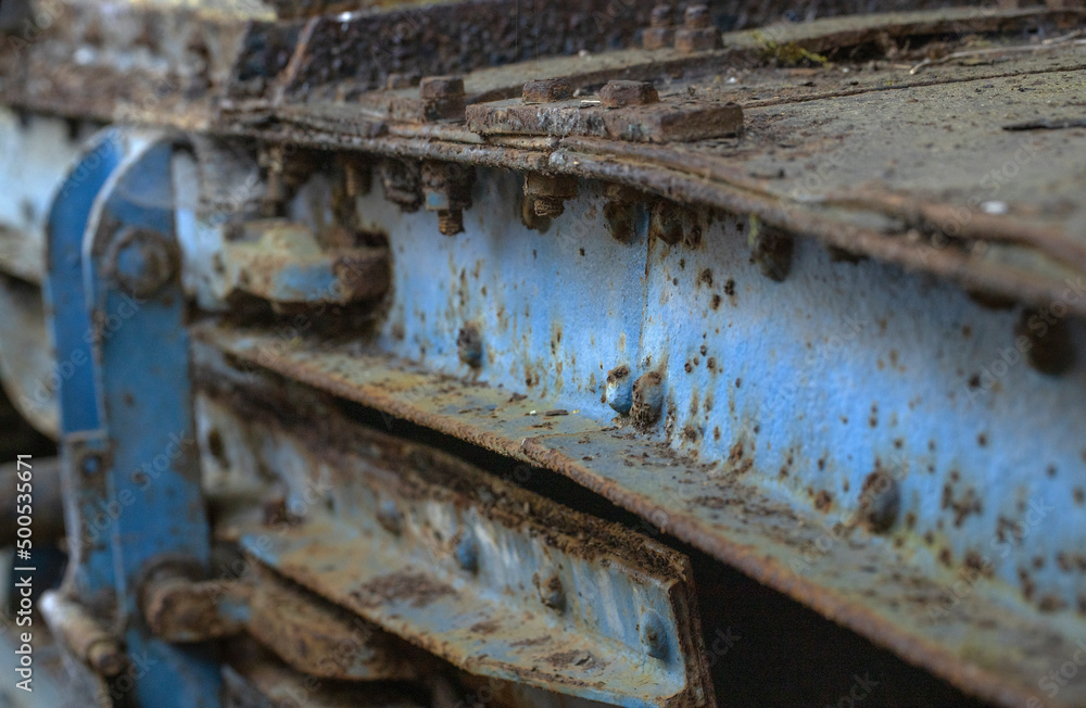 Rusting metal.  At the junkyard. Perished agricultural history. Abandoned and rusted machinery.