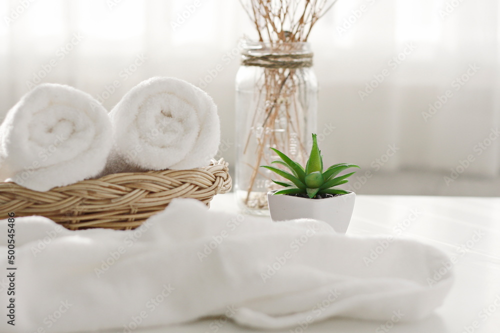 Roll up of colorful towels on white table with copy space For product display montage.health spa concept for products and backgrounds Roll up of colorful towels on white table with copy space For product display montage.health spa concept for products and backgrounds