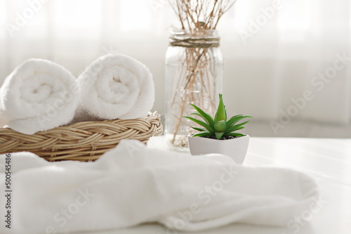 Roll up of colorful towels on white table with copy space For product display montage.health spa concept for products and backgrounds