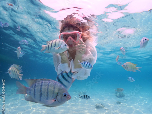 Tourist people diving with snorkel to see nemo fish , beautiful fish and coral at Samaesarn Island of Thailand