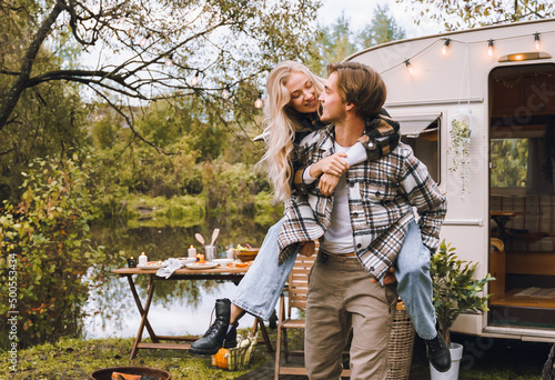 Young just married couple traveling in camper,house on wheels,trailer,motor home.Love romantic road travel,freedom life.Campsite overnight in van.Wanderlust vacation,weekend. Girl,guy,happy adventure