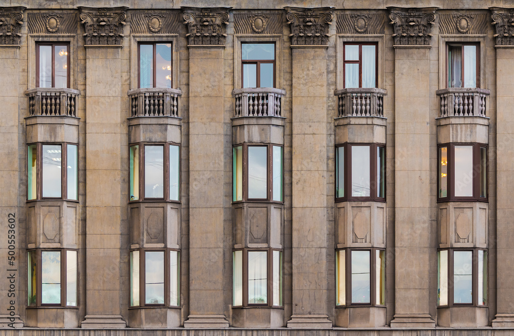 Many windows in a row on the facade of the urban historic apartment building front view, Saint Petersburg, Russia
