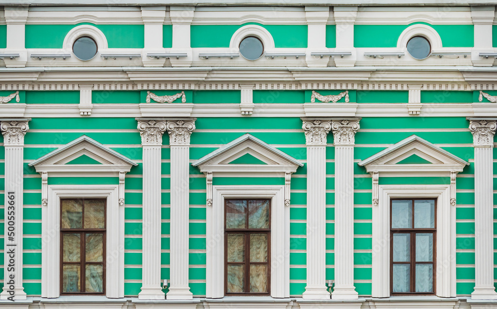 Several pilasters and windows in a row on the facade of the urban historic apartment building front view, Saint Petersburg, Russia
Several pilasters and windows in a row on the facade of the urban historic apartment building front view, Saint Petersburg, Russia