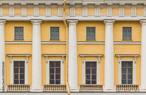 фотографія Columns and several windows in a row on the facade of the urban historic apartme