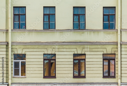 Several windows in a row on the facade of the urban historic apartment building front view, Saint Petersburg, Russia 