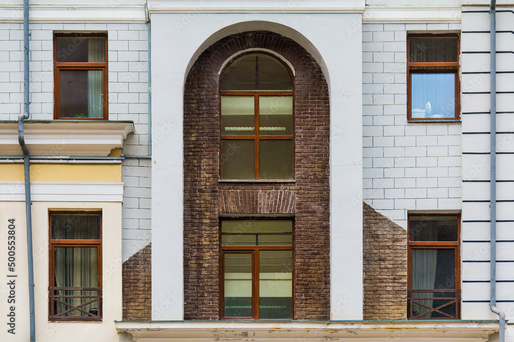 Fototapeta premium Several windows in a row on the facade of the modern urban apartment building front view, Krasnaya Polyana, Sochi, Krasnodar Krai, Russia 