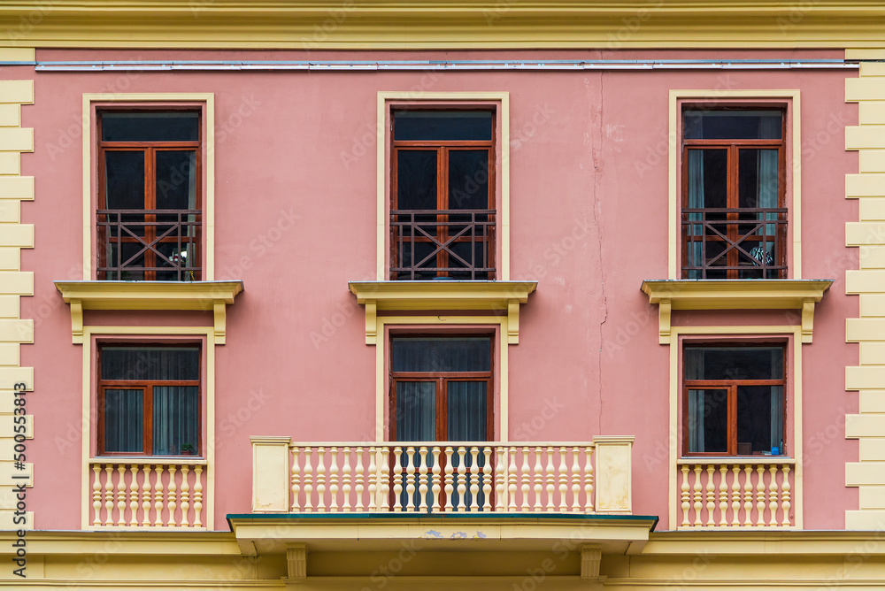 Obraz premium Balcony and several windows in a row on the facade of the modern urban apartment building front view, Krasnaya Polyana, Sochi, Krasnodar Krai, Russia 