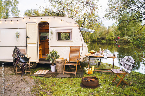 Family traveling in camper,house on wheels,trailer,motor home. Romantic road travel,freedom life.Campsite overnight, parking in van.Wanderlust vacation,weekend. Happy adventure.Relax area with chairs