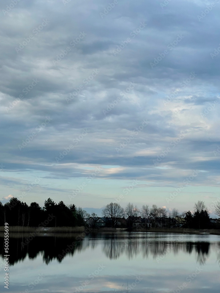 Fototapeta premium sunset over the river, trees in the lake mirror