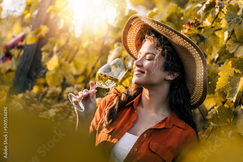 Woman tasting wine in vineyard