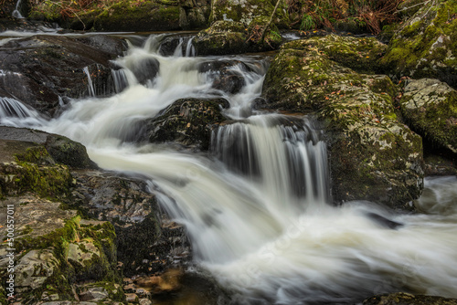 Stunning vibrant landscape image of Aira Force Upper Falls in Lake District during colorful Autumn showing