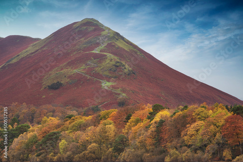 Stunning landscape image of Catbells viewed acros Derwentwater during Autumn in Lake District with mist rolling across the hills and woodland photo