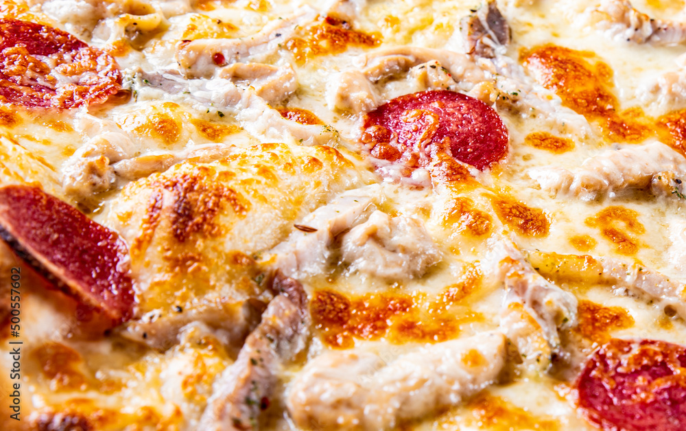 Pizza with Mozzarella cheese, salami, ham, Tomato sauce, pepper, spices. Italian pizza Pizza with Mozzarella cheese, salami, ham, Tomato sauce, pepper, spices. Italian pizza