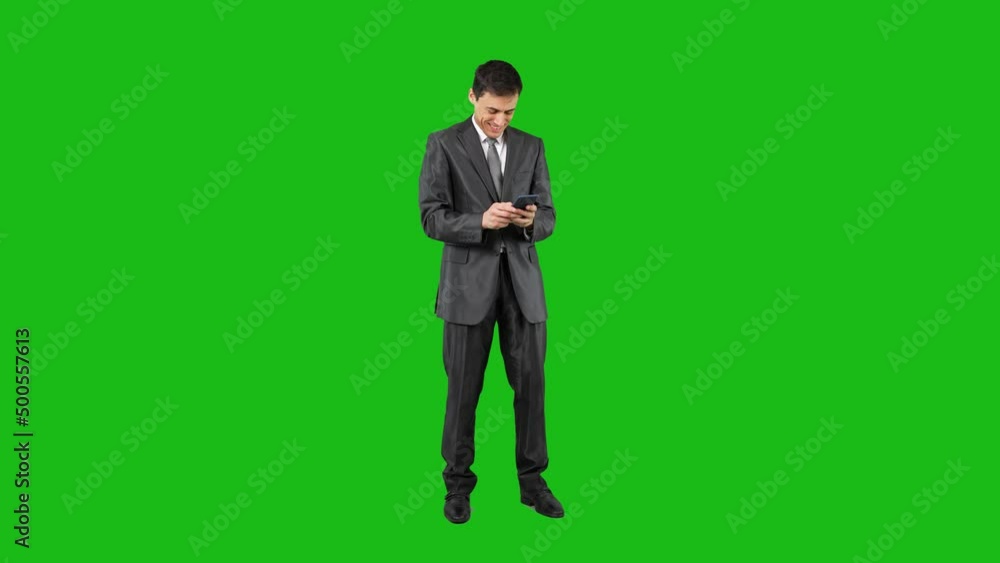 Content businessman writing a message and talking on the phone