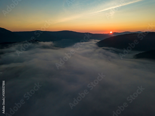 Sunrise over the fog in the Ukrainian Carpathians. Aerial drone view.