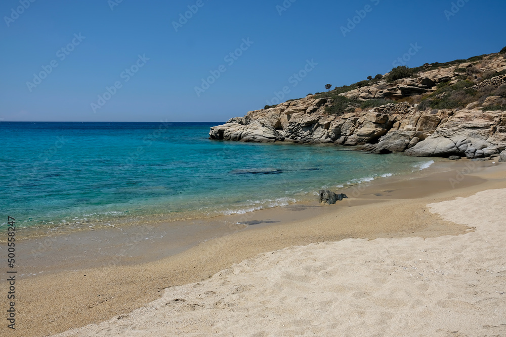 The paradisiac beach with turquoise waters and golden sand of Pikri Nero in Ios Greece
