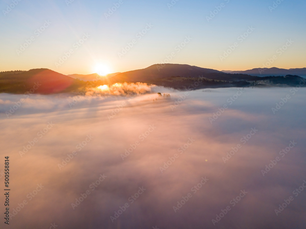 Sunrise over the fog in the Ukrainian Carpathians. Aerial drone view. Sunrise over the fog in the Ukrainian Carpathians. Aerial drone view.