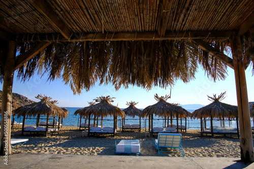 Fototapeta Naklejka Na Ścianę i Meble -  Luxury sunbeds at the famous beach of Mylopotas in Ios Greece