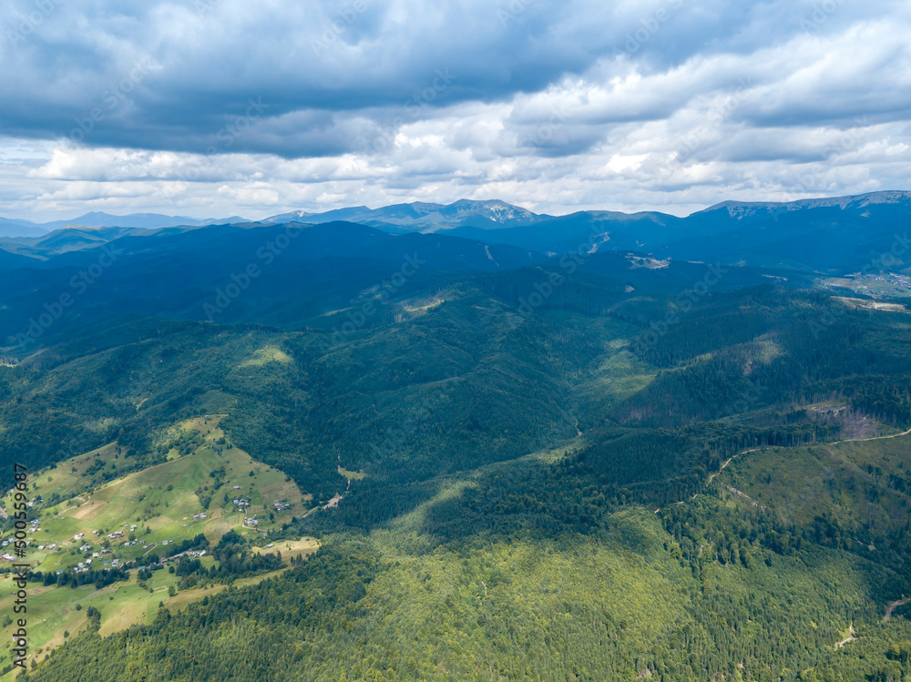 Green mountains of Ukrainian Carpathians in summer. Coniferous trees on the slopes. Aerial drone view. Green mountains of Ukrainian Carpathians in summer. Coniferous trees on the slopes. Aerial drone view.