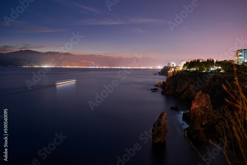 Beautiful night landscape with city on the seashore. Antalya, Turkey.