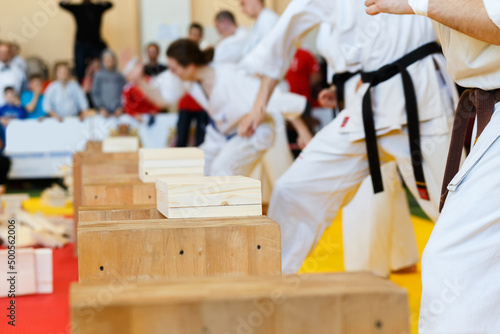 Martial artists breaks the wooden boards by hand photo