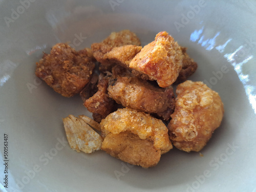 Pork skin fried on a white plate