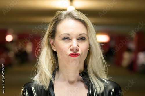 Canvas Print Portrait of beautiful woman with blond hair puckering lips.