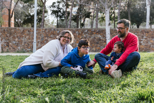 Portrait of a happy family enjoying a day outdoors in the park. © Jordi Mora