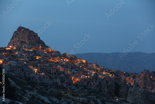 Uchisar town and uchisar castle with lights in the dark , Cappadocia Turkey