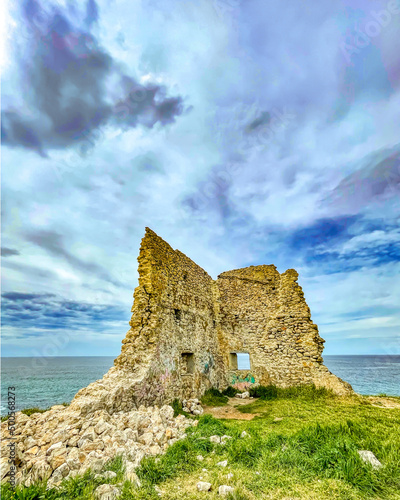 abandoned tower on top of the cliff to the sea